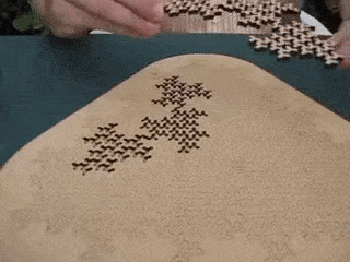 A uniquely shaped puzzle piece slides into place in a finished puzzle